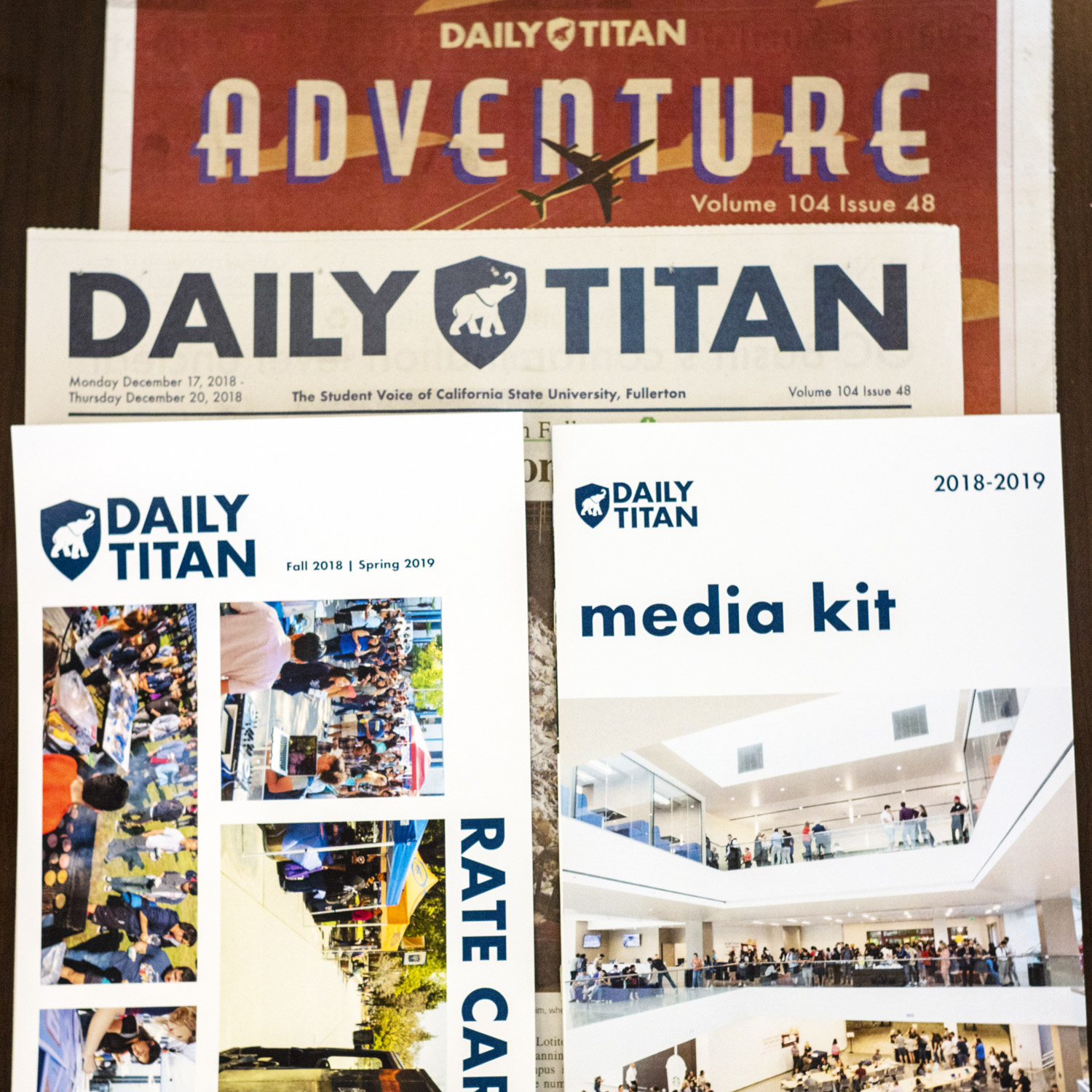 New Daily Titan logo on rate card, media kit, daily newspaper, and special publication.